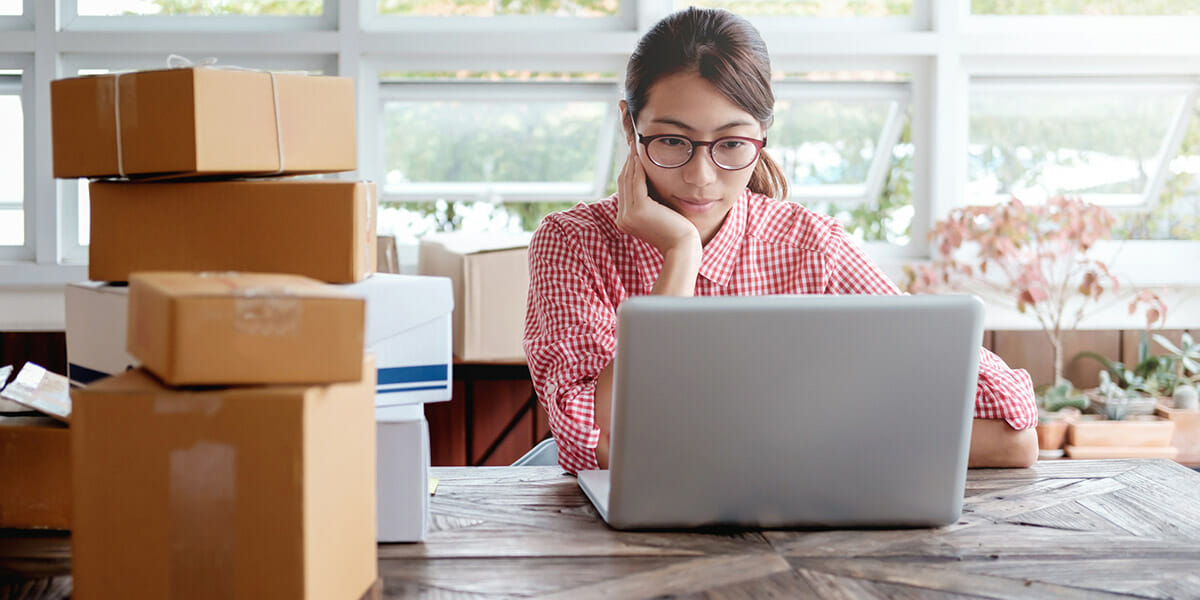 Woman sitting looking at laptop