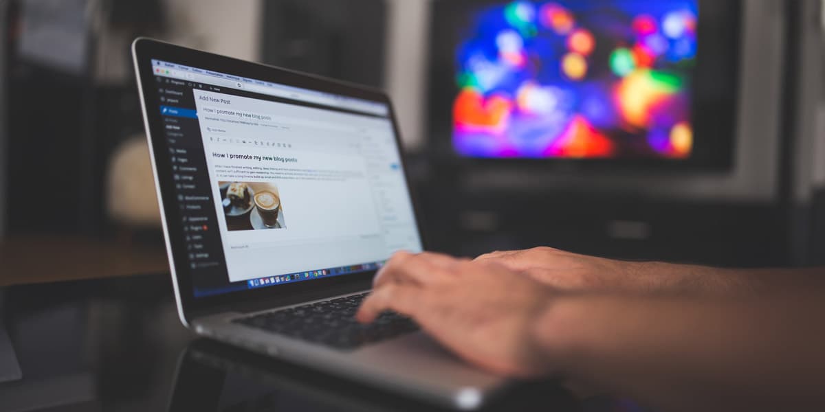 A person typing on a laptop screen, focused and engaged in their work.