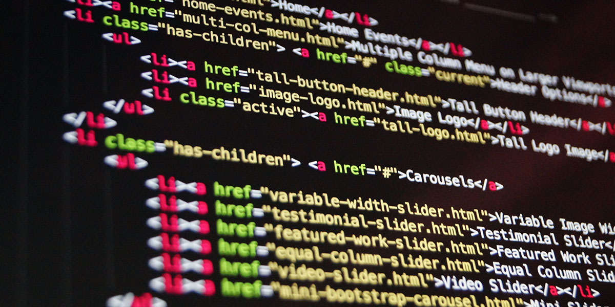 Close-up of HTML code with colorful syntax highlighting displayed on a dark screen.