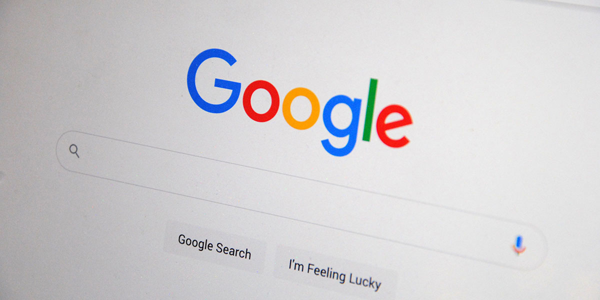 A close-up of the Google homepage showing the logo and search bar on a screen.